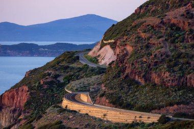 Scenic Highway on the Sea Coast during Sunny Fall Season Sunset. Sardinia, Italy. Adventure Travel