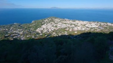 Touristic Town on Capri Island, Bay of Naples, Italy. Sunny Blue Sky. Nature Background. View from top of Mountain. Slow Motion Cinematic