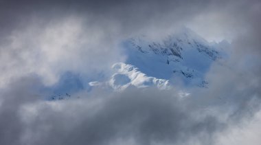 Tantalus Range covered in Snow and Clouds during Winter Season. Near Whistler and Squamish, British Columbia, Canada. Nature Background