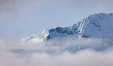 Tantalus Range covered in Snow and Clouds during Winter Season. Near Whistler and Squamish, British Columbia, Canada. Nature Background