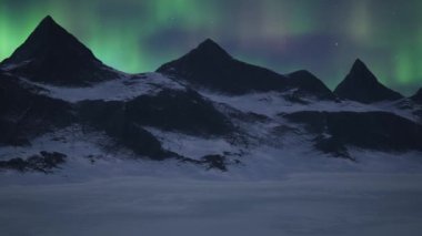 Rocky Mountain Landscape at night with Stars and Northern Lights in Sky. 3d Rendering Artwork. Aerial Cinematic Animation