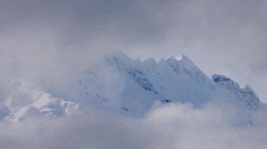 Snow and Cloud covered Canadian Nature Landscape Background. Winter Season in Squamish, British Columbia, Canada. Sunny Sky. Slow Motion