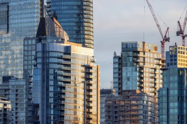 Highrise Residential and Commercial Buildings in Modern Downtown City. Vancouver, British Columbia, Canada. Winter Sunset.