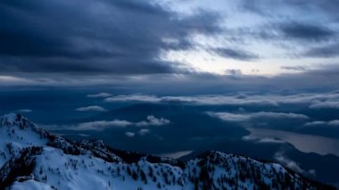 Aerial view of a Canadian Landscape during a winter sunset. Taken in Howe Sound, North of Vancouver, British Columbia, Canada. Cinemagraph Continuous Loop Animation