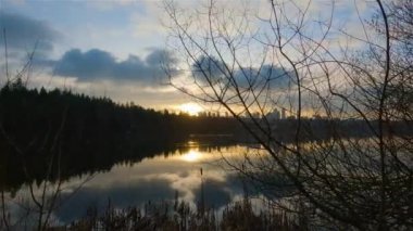 Trail by Peaceful Lake in the modern city, Deer Lake Park. Burnaby, Vancouver, BC, Canada. Colorful Winter Sunset Sky. Slow Motion Cinematic Pan.