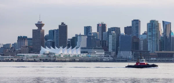 stock image Vancouver, BC, Canada - March 18, 2023: Tug Boat in front of Canada Place and Downtown City.