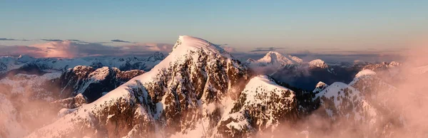 Coastal Canadian Mountain Landscape covered in Snow. Aerial View from Airplane. Near Vancouver, British Columbia, Canada. Nature Background. Panorama
