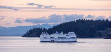 West Vancouver, British Columbia, Canada - April 14, 2023: BC Ferries leaving the Horseshoe Bay Terminal in Howe Sound during colorful Sunset. clipart