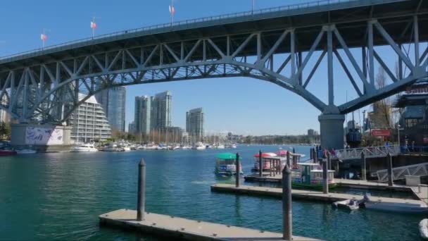加拿大不列颠哥伦比亚省温哥华市中心 2023年3月30日 位于格兰维尔岛 Granville Island 的小渡船 背景为城市景观 艳阳天 — 图库视频影像