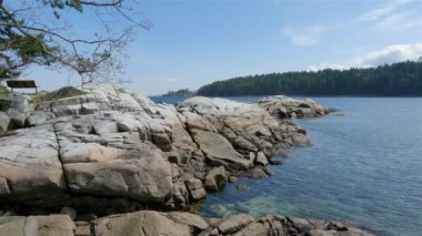 Nanoose Körfezi 'ndeki Pasifik Okyanusu' nun batı kıyısındaki Rocky Shore. Vancouver Adası, British Columbia, Kanada. Güneşli Gökyüzü. Kanada Doğa Arkaplanı