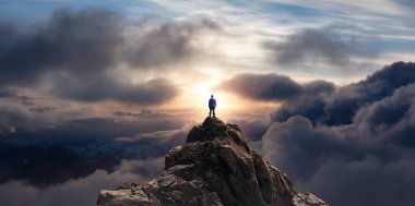 Adventurous Man Standing on top of Mountain Cliff. Extreme Adventure Composite. 3d Rendering Peak. Background Aerial Image from British Columbia, Canada. clipart