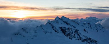 Dağ Tepesi karla kaplıydı. Kanada Doğa Havacılık Arkaplanı. British Columbia, Kanada. Günbatımı Gökyüzü