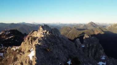 Karla kaplı Rocky Dağı zirvesi. Güneşli Günbatımı. Havadan. British Columbia, Kanada.
