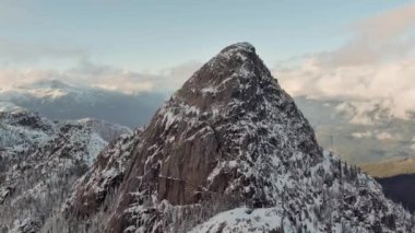 Karla kaplı Rocky Dağı zirvesi. Dramatik Bulutlu Gün Batımı. Havadan. British Columbia, Kanada. Yüksek kalite 4k görüntü