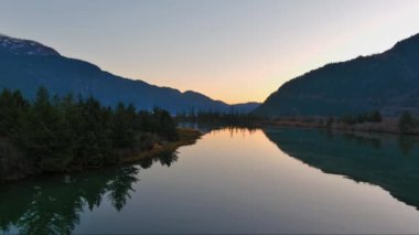 Kanada doğasında dağlar ve ağaçlarla çevrili bir göl. Sonbahar sezonu, Günbatımı Gökyüzü. Squamish, İngiliz Kolombiyası Kanada.