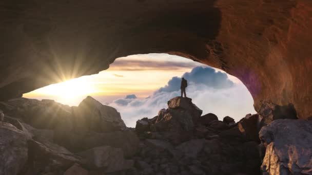 Adventurous Man Hiker Standing Rocky Cave Puffy Clouds Background Adventure — Stock Video