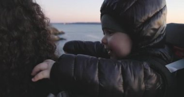 Baby Boy, okyanus kıyısında Rock 'ta doğa yürüyüşü yapan bir gemide annesiyle oynaşıyor. Fener Parkı, Batı Vancouver, BC, Kanada.