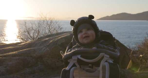 Close Baby Boy Sorrindo Sentado Transportador Caminhadas Rock Pela Costa — Vídeo de Stock