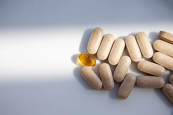 Yakın plan - beyaz arka planda bir yığın hap. Sağlık ve sağlık hizmetleri kavramı. şeffaf kapsül