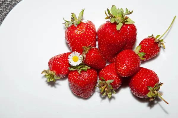 Beyaz bir tabak taze kırmızı çilek