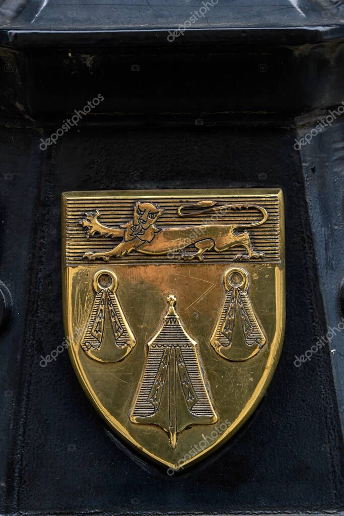 LONDON, UK - MAY 21, 2025:  Brass Coats of Arms of the Worshipful Company  of Merchant Taylors the on the street lights on Cornhill outside the Royal Exchange