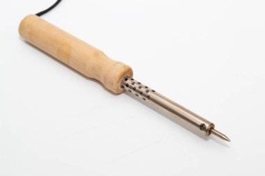 Ahşap saplı lehim demiri, siyah kablosu ve beyaz bir yüzeyde duran iki uçlu dolgusu..