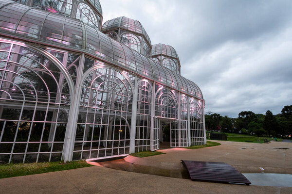 Beautiful view to glass greenhouse building in botanical garden, Curitiba, capital of Paran, Brazil.