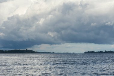 Beautiful view to green rainforest river and clouds in the Brazilian Amazon, Amazonas, Brazil