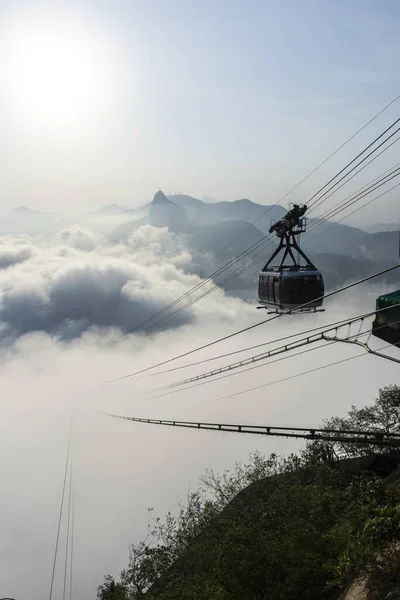 Beautiful view to Sugar Loaf Mountain cable car above the clouds in Rio de Janeiro, Brazil
