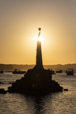Rio Grande do Norte Eyaleti, Brezilya 'daki Pipa köyündeki kayalık okyanus heykeli üzerine küçük bir aziz heykeli