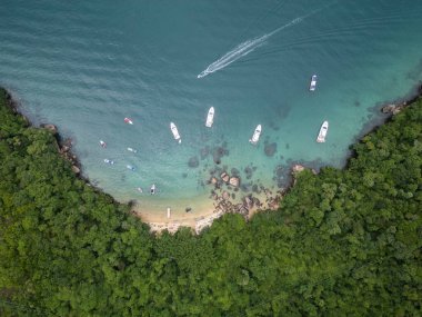 Feiticeira Sahili 'ne güzel hava manzarası, kayalar, yeşil yağmur ormanları ve zümrüt suları üzerindeki tekneler, Ilha Grande, Rio de Janeiro, Brezilya
