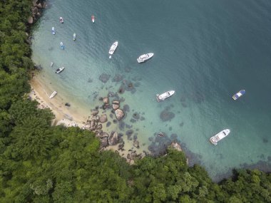 Feiticeira Sahili 'ne güzel hava manzarası, kayalar, yeşil yağmur ormanları ve zümrüt suları üzerindeki tekneler, Ilha Grande, Rio de Janeiro, Brezilya