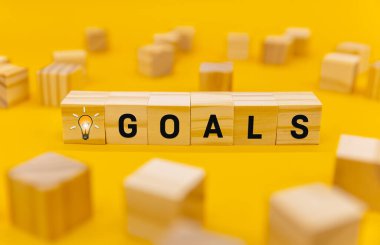 Representation of GOALS on wooden cubes. Business performance target and objective target concept.