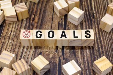 Representation of GOALS on wooden cubes. Business performance target and objective target concept.