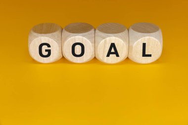 Representation of GOALS on wooden cubes. Business performance target and objective target concept.