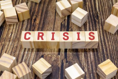 Wooden cubes with sign crisis, business financial loss, crisis concept