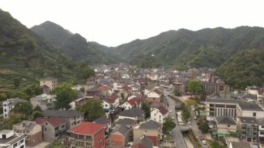 Çin 'in Hangzhou Zhejiang bölgesindeki batı gölü yakınlarındaki çay tepesinin ve köylerin havadan görüntüsü. Yüksek kalite 4k görüntü