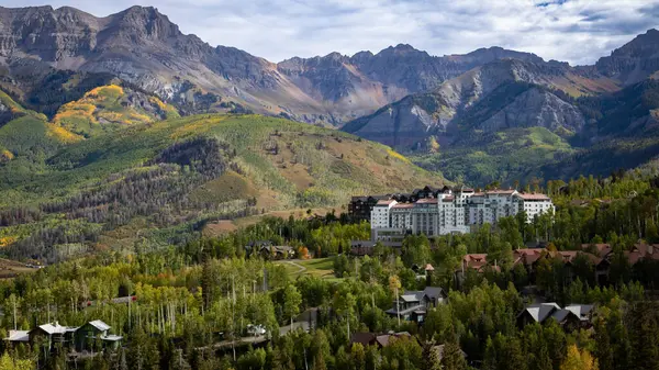 Telluride, Colorado 'nun panoramik bir manzarası. Görkemli San Juan Dağları' nın eteklerinde bulunan lüks bir tatil köyü, sonbaharın zirvesinde altın kalemlerle ve canlı yapraklarla çevrili..