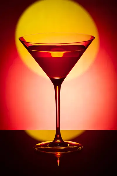 Glass martini glass on a red background