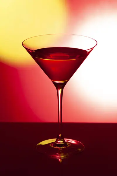 Glass martini glass on a red background