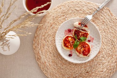 Sabah tazeliğini kızarmış tvorog kreplerine batır. Kahvaltı ya da öğlen atıştırması için birebirdir. Hafif ve lezzetli yemekler nane yaprakları ve parlak nar tohumlarıyla servis edilir. Tazelik ve görsel cazibe kazandırır. Servis edildi. 