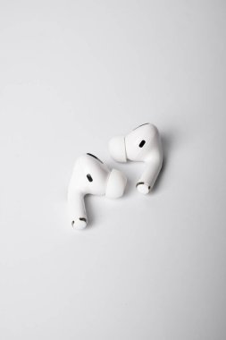 Temiz, beyaz bir arka plana yerleştirilmiş silikon uçlu bir çift kablosuz kulaklık. Gösterişli, minimalist tasarım modern ses teknolojisini ve günlük taşınabilir kolaylığı vurguluyor.