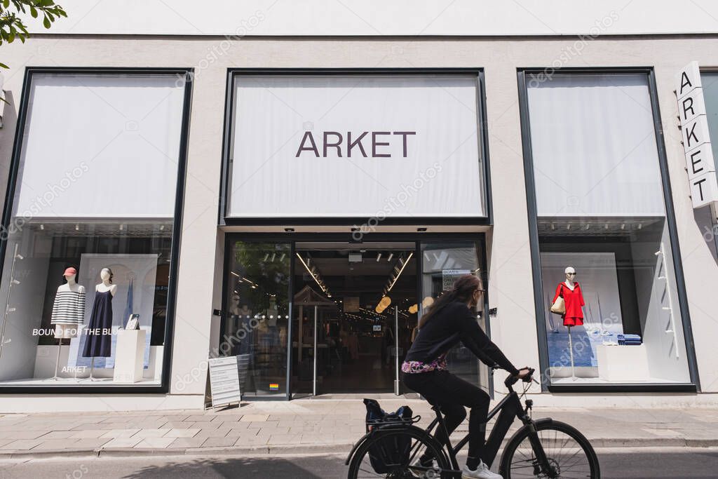 Minimalist ARKET shop exterior with mannequins and fashion items