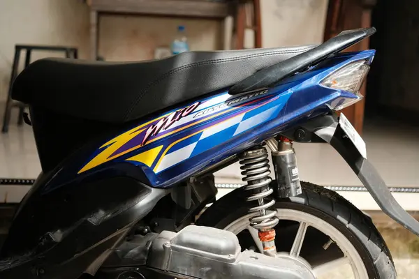 Denpasar, Bali - 07 Mayıs 2025: Yakın çekim Yamaha Mio otomatik scooter 'ın siyah desenli koltuğu ve mavi yan gövdesine odaklanır.