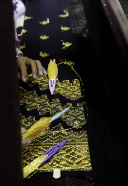 Weaver, Pekanbaru 'daki Kampung Bandar Tenun Evi' nde geleneksel Riau Malay şarkısı dokuyor..