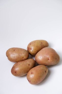 Beyaz arkaplanda kırmızı patatesin seçici odak noktası
