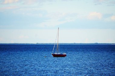Panoramic view of the Baltic Sea, rough waters, waves hitting the shore, Polish coastline, seaside vacation, natural landscape, dramatic sky, and coastal nature.