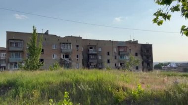 Damaged and burnt out multi-storey houses in spring time. Ukraine, near Kyiv. War destroyed peace life. war consequences