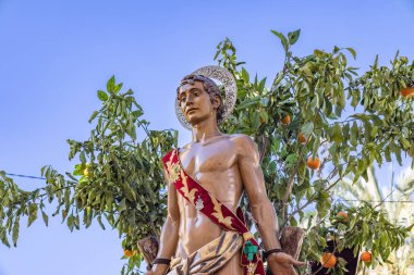 Detail of the Patron Saint Sebastian (San Sebastian)  in procession through the streets of the city of Huelva