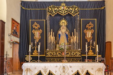 Huelva, Spain - January 22, 2023: Paso de Semana Santa (Platform or Throne) of Our Lady of Loneliness (Nuestra Senora de la Soledad) inside of the Hermitage of La Soledad